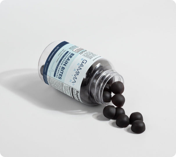 Gamma Brain mushroom gummies spilling from an open bottle on a white background.